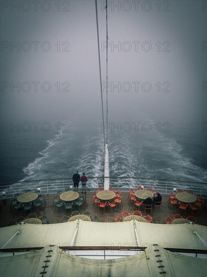 Stern of a cruise ship in the fog in a gloomy atmosphere