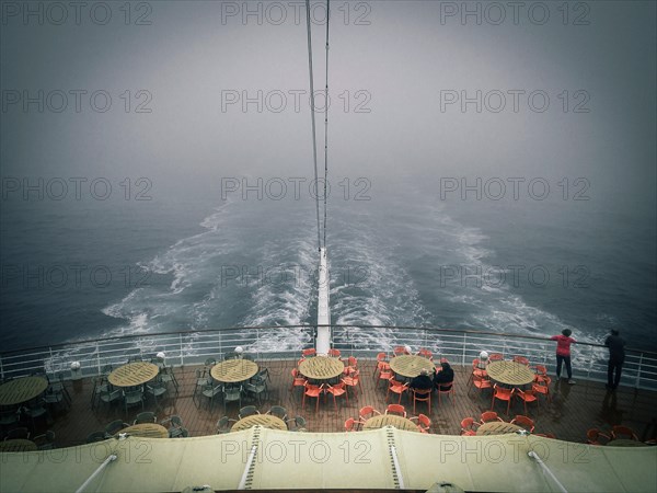 Stern of a cruise ship in the fog in a gloomy atmosphere