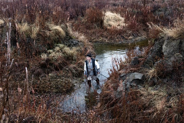 Scientist Sergei Zimov examines a varnish in an area where permafrost is rapidly thawing