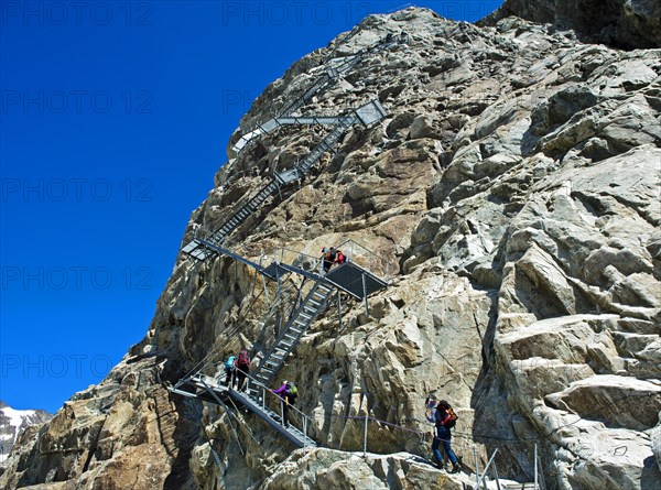 Metal stairs on a rock face as a train access to the Konkordiahütte mountain hut