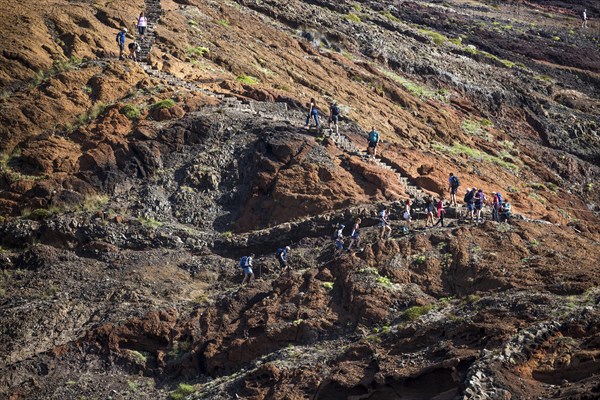 Hikers on a trail with rock formations