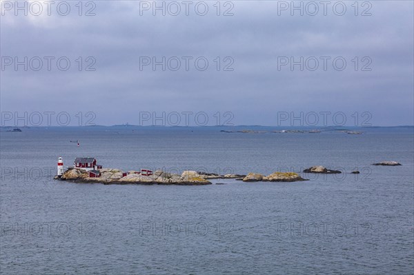 Typical tiny archipelago island with lighthouse and lighthouse keeper's house