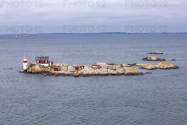 Typical tiny archipelago island with lighthouse and lighthouse keeper's house