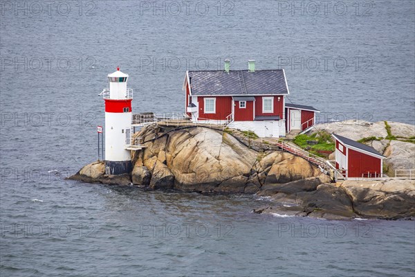 Typical tiny archipelago island with lighthouse and lighthouse keeper's house