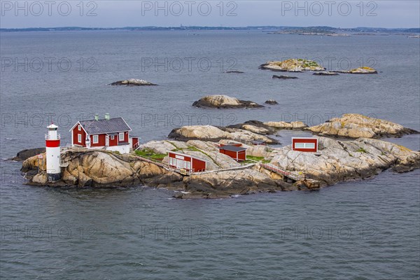 Typical tiny archipelago island with lighthouse and lighthouse keeper's house