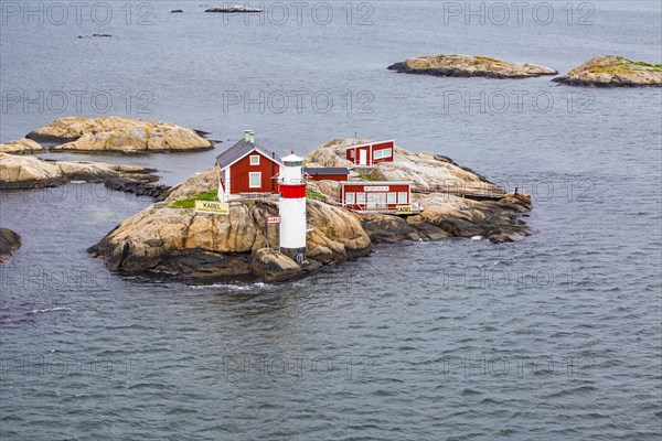 Typical tiny archipelago island with lighthouse and lighthouse keeper's house