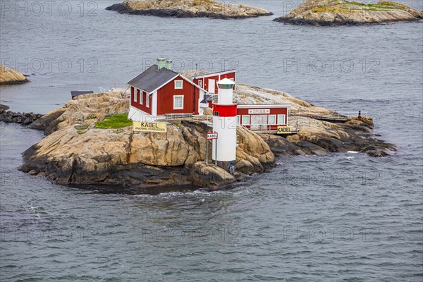 Typical tiny archipelago island with lighthouse and lighthouse keeper's house