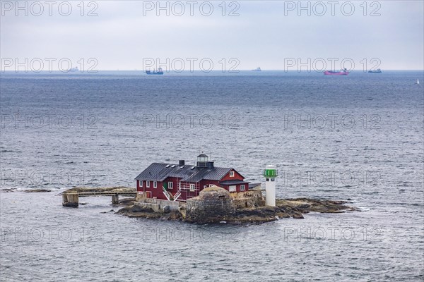 Typical tiny archipelago island with lighthouse and lighthouse keeper's house