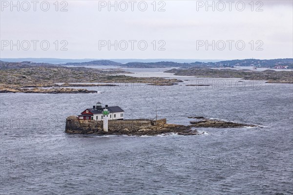 Typical tiny archipelago island with lighthouse and lighthouse keeper's house