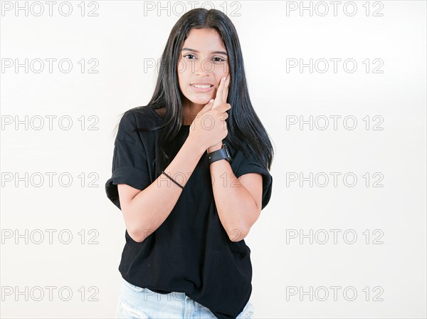 Young girl suffering with toothache isolated. Girl rubbing cheek with toothache on white background