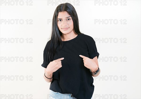 Embarrassed young woman pointing at herself isolated. Confused girl pointing at herself isolated