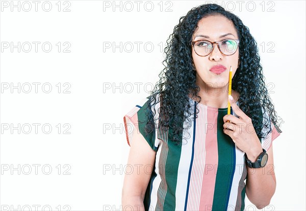 Thoughtful young woman in glasses holding a pencil. Afro girl thinking holding pencil on chin