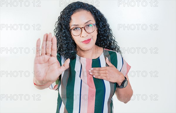 Afro girl gesturing stop isolated. Latin girl gesturing stop with palm hand isolated. Young afro woman rejecting with the palm hand isolated