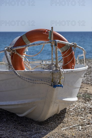 Boat with life belt on the beach