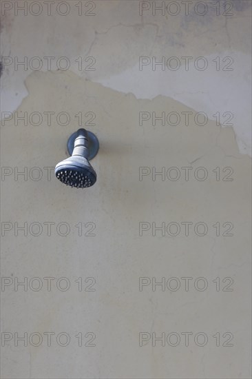 Shower on a weathered wall on the beach