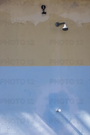 Shower on a weathered wall on the beach