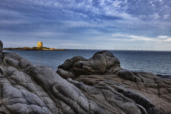 Bizarre rock formations on the beach in front of the Torre di Bari Sardo in the evening light