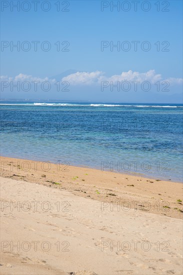 Sunrise on the sandy beach. Landscape shot with a view of the sea and the beach. Waves of light and a morning atmosphere that only exists in Sanur