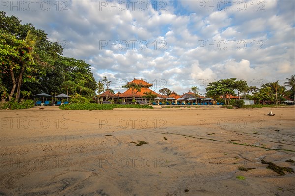 Sunrise on the sandy beach. Landscape shot with a view of the sea and the beach. Waves of light and a morning atmosphere that only exists in Sanur