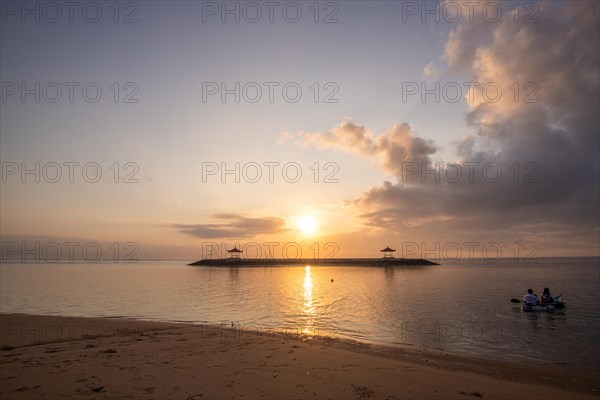 Sunrise on the sandy beach. Landscape shot with a view of the sea and the beach. Waves of light and a morning atmosphere that only exists in Sanur