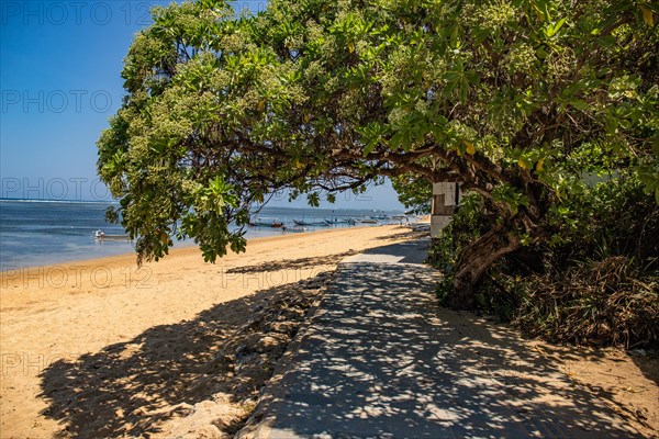 Sunrise on the sandy beach. Landscape shot with a view of the sea and the beach. Waves of light and a morning atmosphere that only exists in Sanur