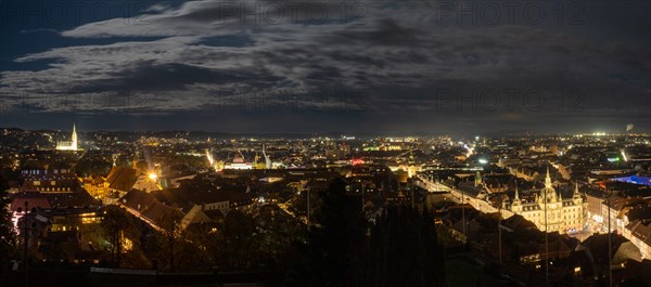 View of the city of Graz illuminated at night from the Schlossberg