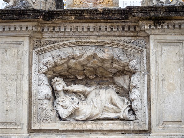 Reclining figure of a saint