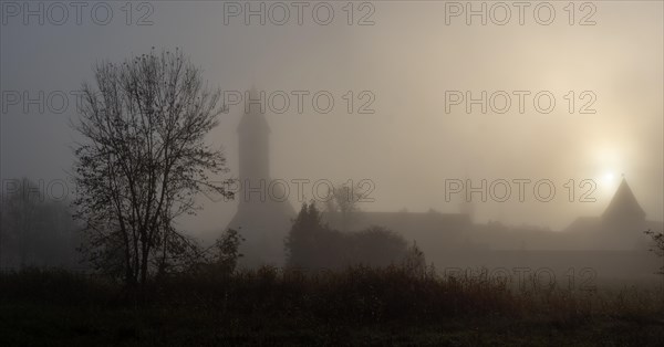 Church tower in the morning mist