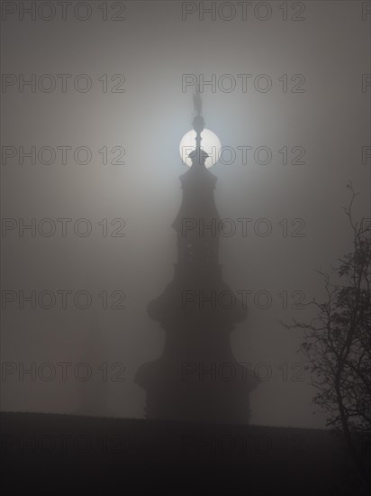 Church tower in the morning mist