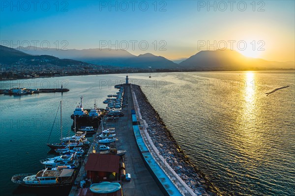 Sunrise over Lighthouse and Marina from a drone