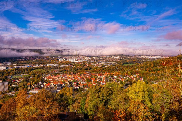 View of Jena in autumn in the morning with rising fog and blue sky