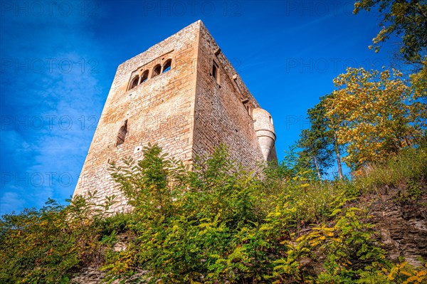 View of Lobdeburg Castle in autumn with blue sky and veil clouds