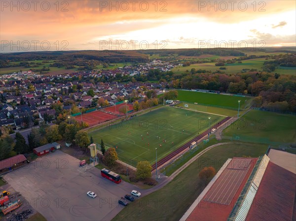 Football pitch in small village at sunset