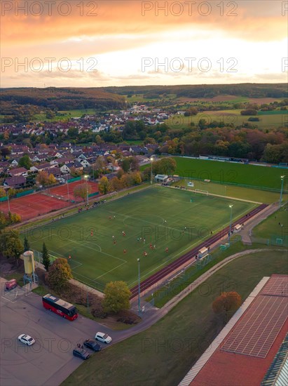 Football pitch in small village at sunset