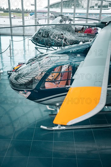 Helicopter in Modern Glass Architecture at Redbull Hangar7