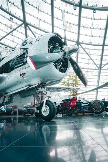 Historic aircraft in modern glass architecture in Redbull Hangar7