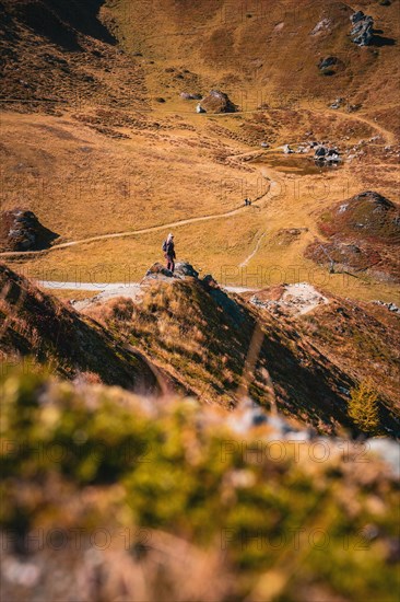 Woman on mountain top in hardworking mountains