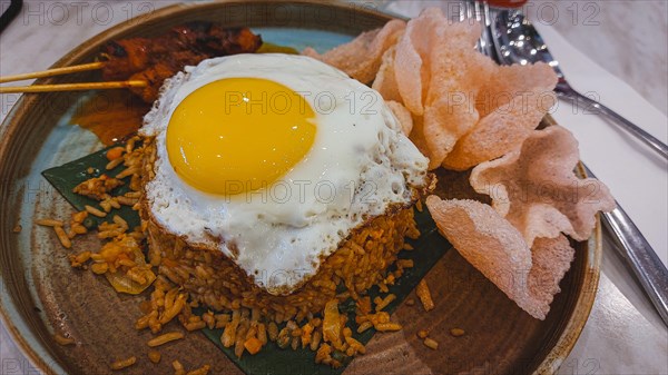 Malaysian fried rice or nasi goreng with chicken satay