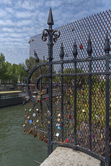 Love locks on a barrier on the Seine