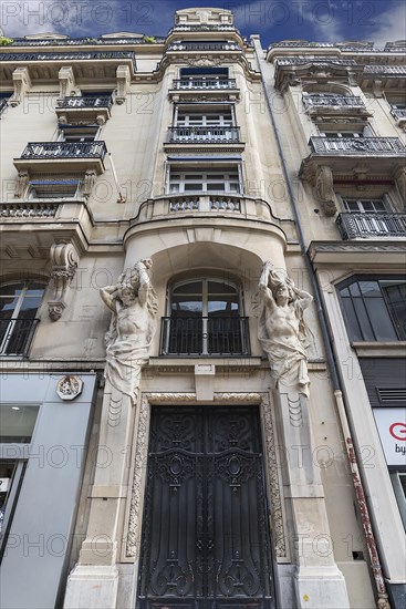 Artfully designed entrance with atlases of a historic residence