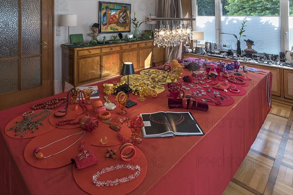 Jewellery decorated on a large table and chest of drawers