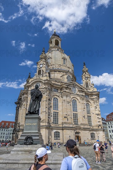 Tourists in front of the monument of the reformer Martin Luther