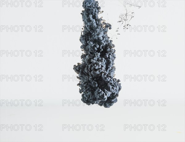 Abstract heavy gray ink drop falling