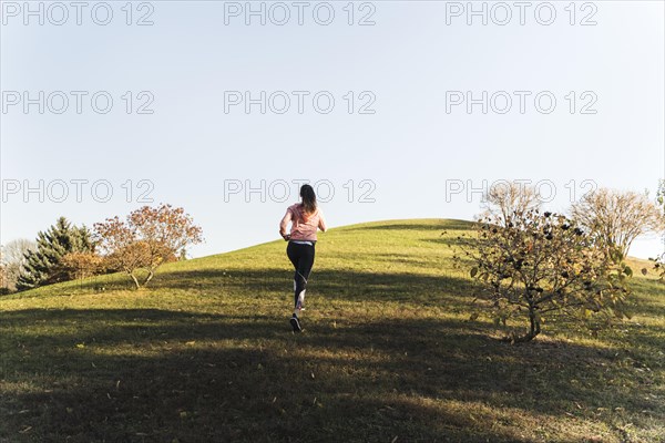 Active young woman running park