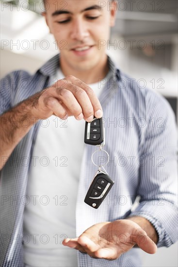 Adult male holding car keys