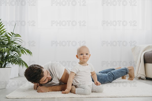 Baby standing floor home with father