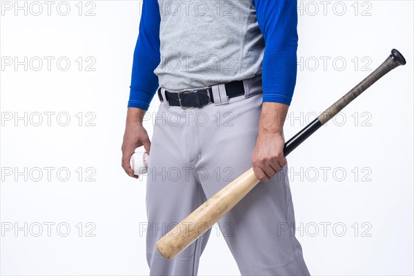 Baseball player holding bat ball