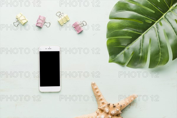 Beach holiday composition with phone light background