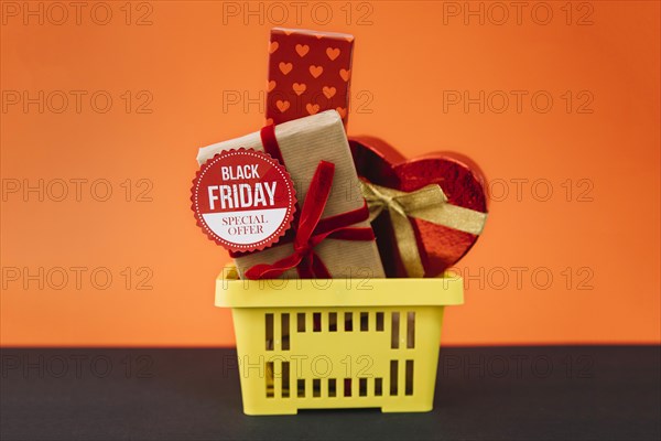 Black friday decoration with gifts shopping basket