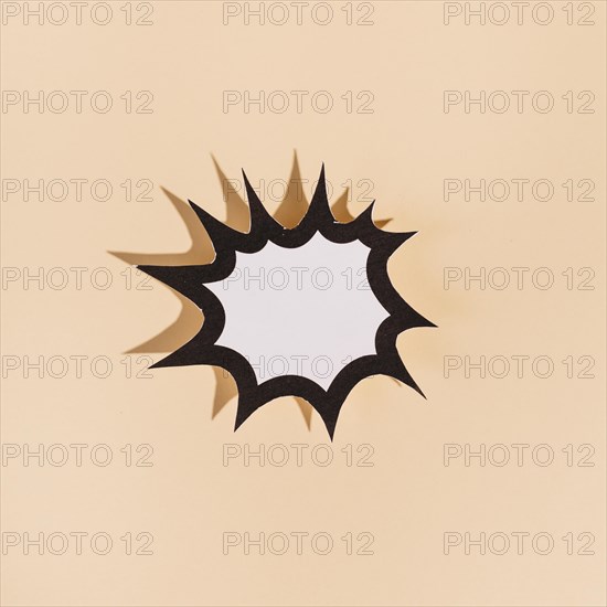 Blank white paper cut out explosion speech bubble beige background